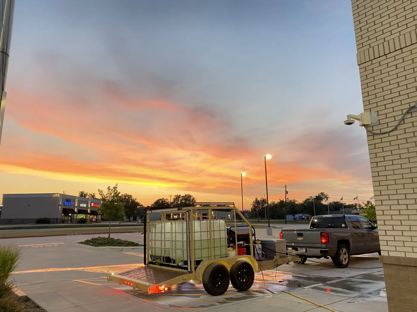 B&H wash trailer and truck set up at a storefront at sunset